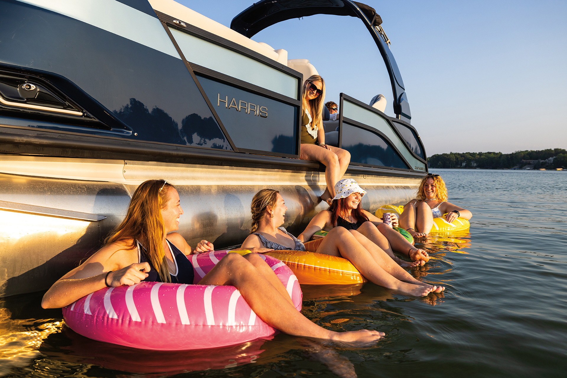 Group of friends enjoying the lake on a Harris Pontoon