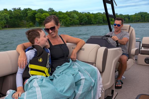Family enjoying a day on Six Mile Lake on a Harris Pontoon